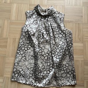 Fun ivory and brown party top with button up back. Size small.